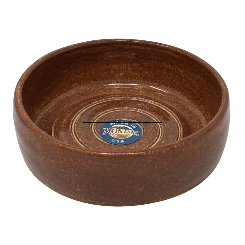 Brown ceramic bowl with 'Montana Silversmiths' logo on a white background