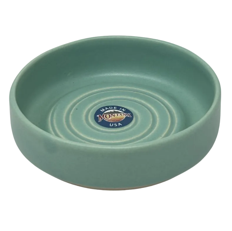 Green ceramic bowl with 'Made in Montana USA' label on a white background