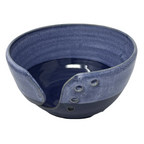 Blue ceramic bowl with textured surface on a white background